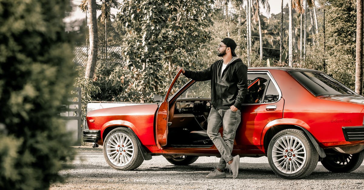 Can I legally drive in France with an Indian driving licence? - Man in Black Jacket and Pants Leaning on Red Car Can I legally drive in France with an Indian driving licence? - Man in Black Jacket and Pants Leaning on Red Car