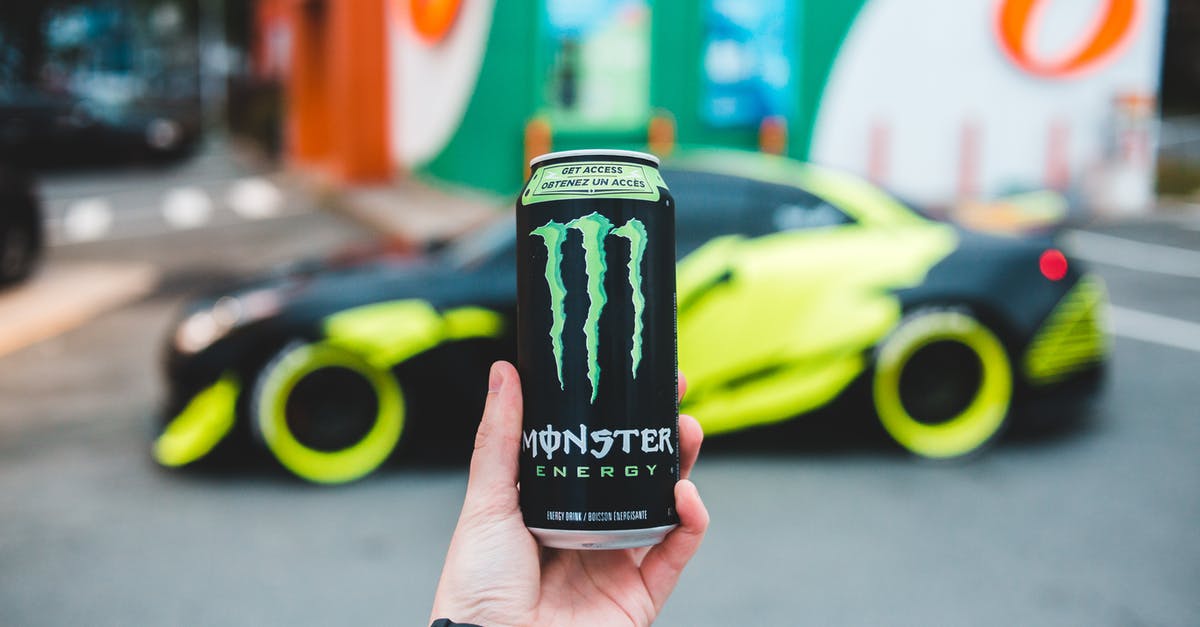 Can I legally drive through the backstreets in Seattle? - Unrecognizable person holding can of power drink while standing on parking lot near sport car Can I legally drive through the backstreets in Seattle? - Unrecognizable person holding can of power drink while standing on parking lot near sport car