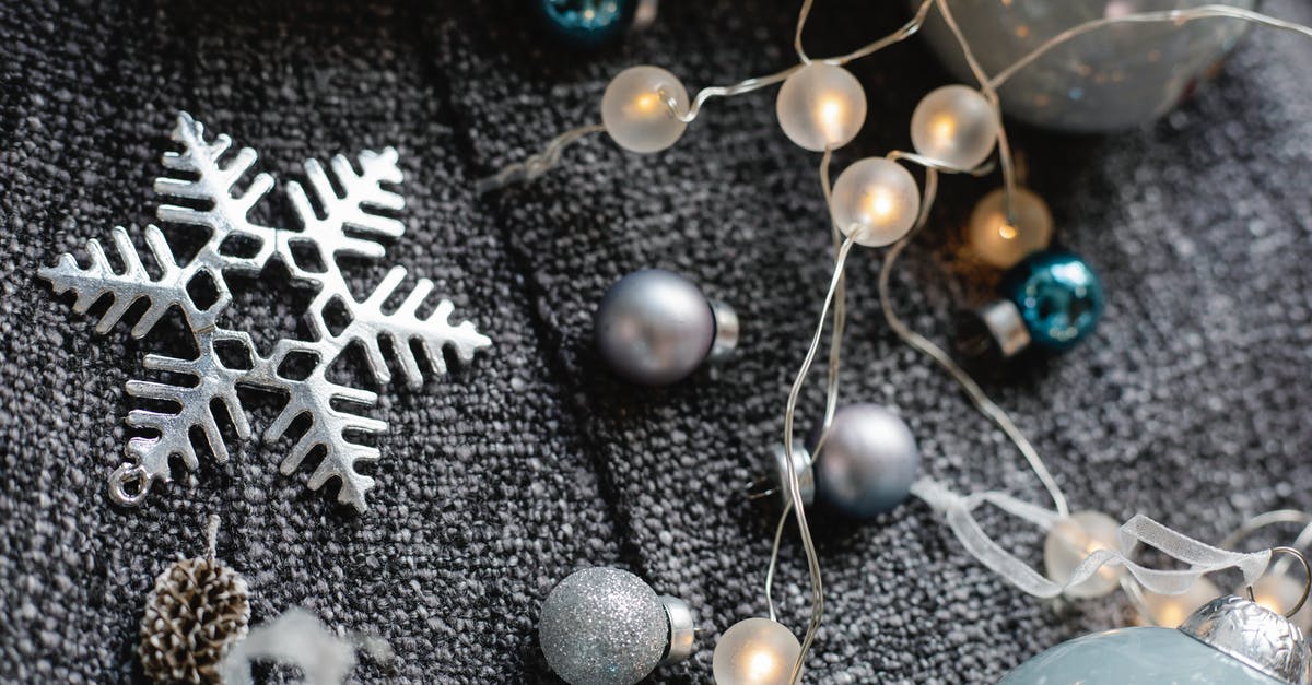 Can I merge points from different flight companies to use in Star Alliance? - From above of decorative baubles with shiny garland with star near fir cone