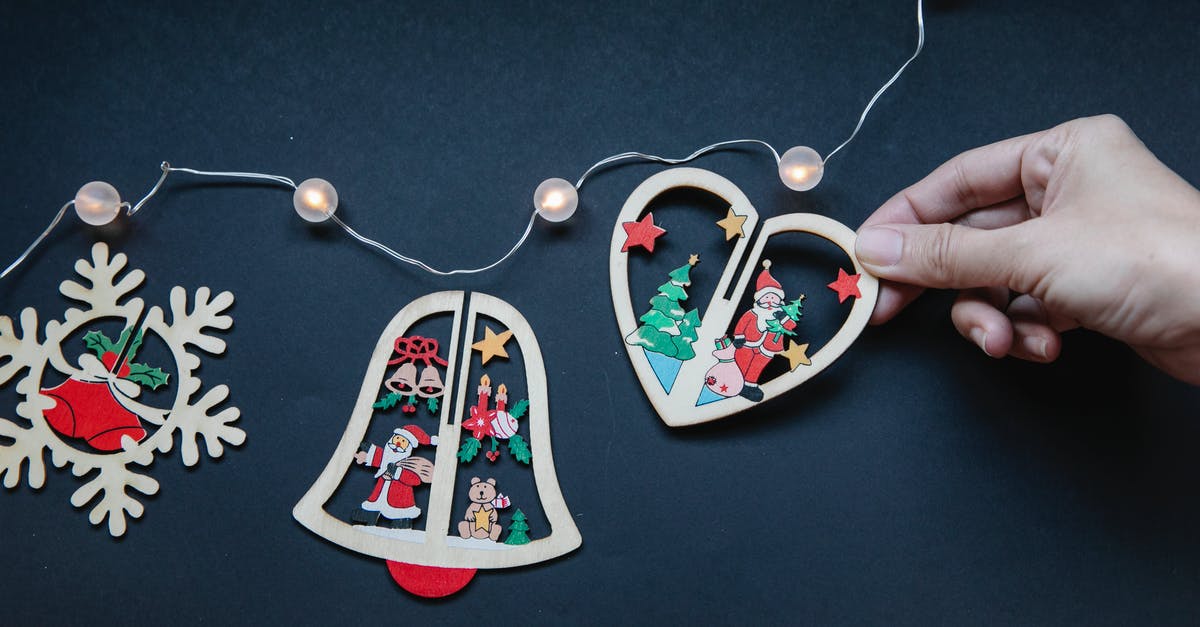 Can I merge points from different flight companies to use in Star Alliance? - Faceless person near Christmas decorations with garland on surface