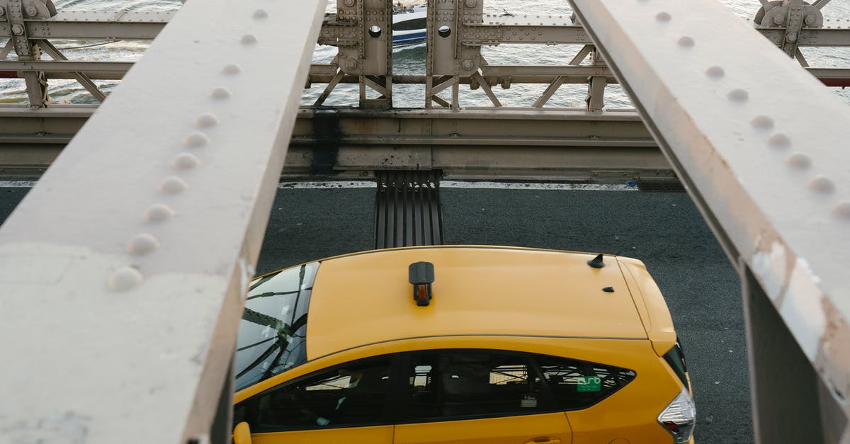 Can I move to Germany from the US during COVID? - Yellow cab driving on metal bridge