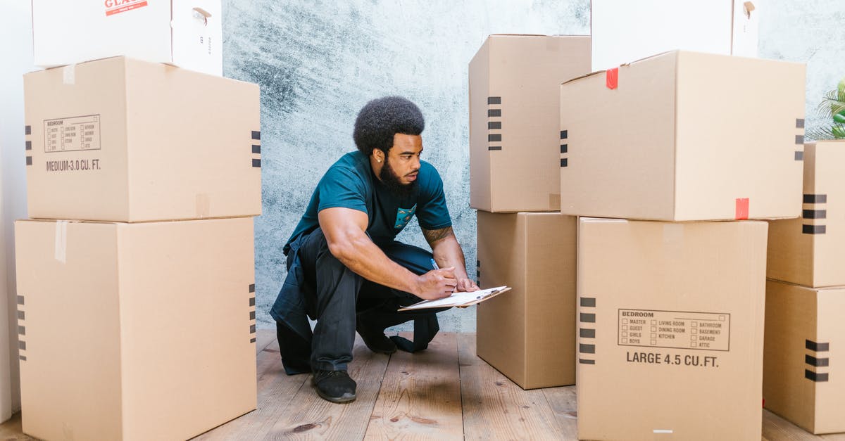 Can I opt out of checking carry-on at the gate? - A Bearded Man Crouching Looking at Cardboard Boxes Can I opt out of checking carry-on at the gate? - A Bearded Man Crouching Looking at Cardboard Boxes