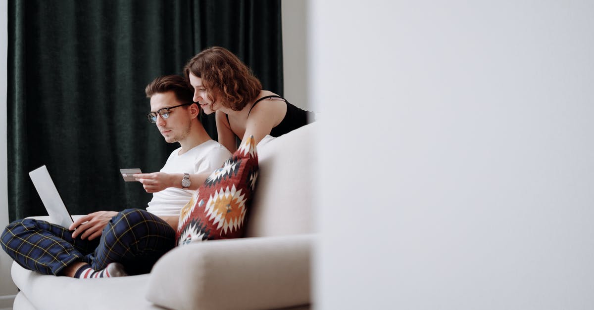 Can I purchase a round-trip and a one-way on the same flight sitting together? - Woman Holding a Credit Card in Front of a Man Can I purchase a round-trip and a one-way on the same flight sitting together? - Woman Holding a Credit Card in Front of a Man