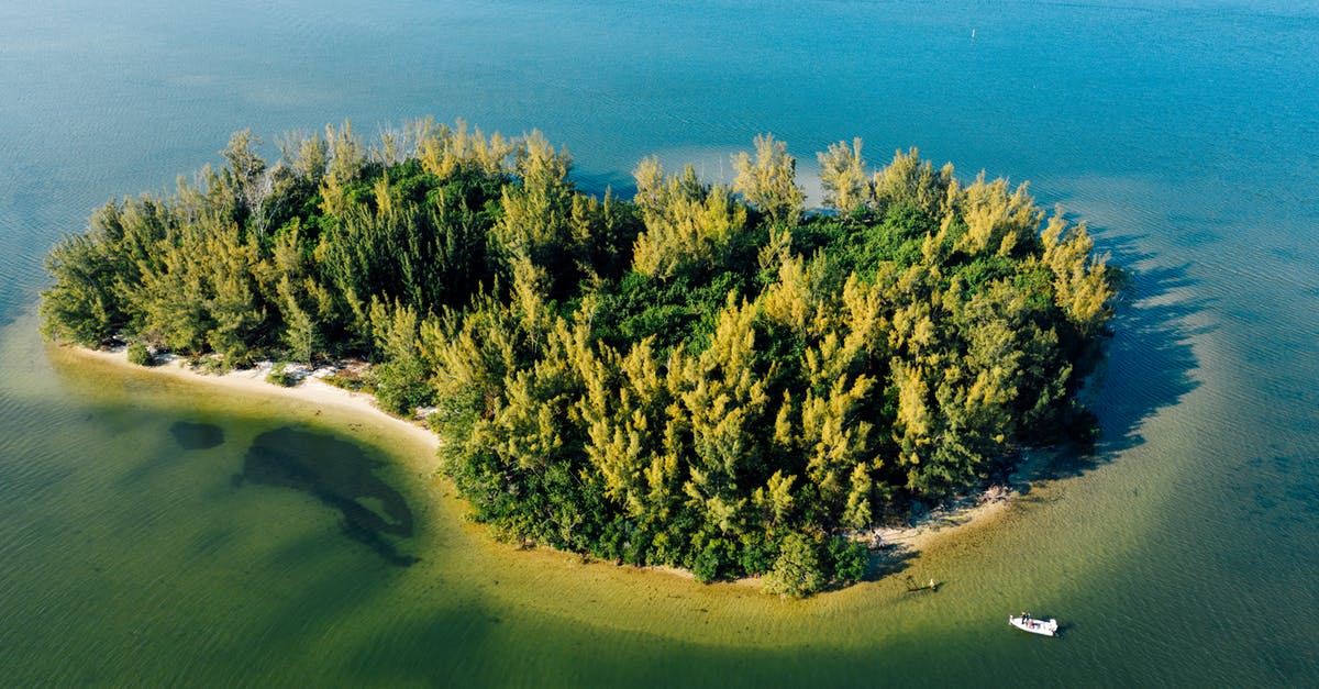 Can I rent a motorized boat on Koh Phi Phi Don without a license? - Aerial view of picturesque island with growing bright trees near picturesque ocean and motor boat in daylight in summertime Can I rent a motorized boat on Koh Phi Phi Don without a license? - Aerial view of picturesque island with growing bright trees near picturesque ocean and motor boat in daylight in summertime