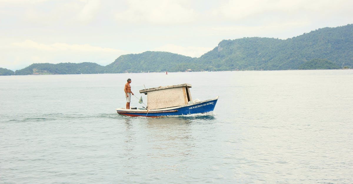 Can I rent a motorized boat on Koh Phi Phi Don without a license? - Unrecognizable fisherman catching fish on boat with rod on lake Can I rent a motorized boat on Koh Phi Phi Don without a license? - Unrecognizable fisherman catching fish on boat with rod on lake