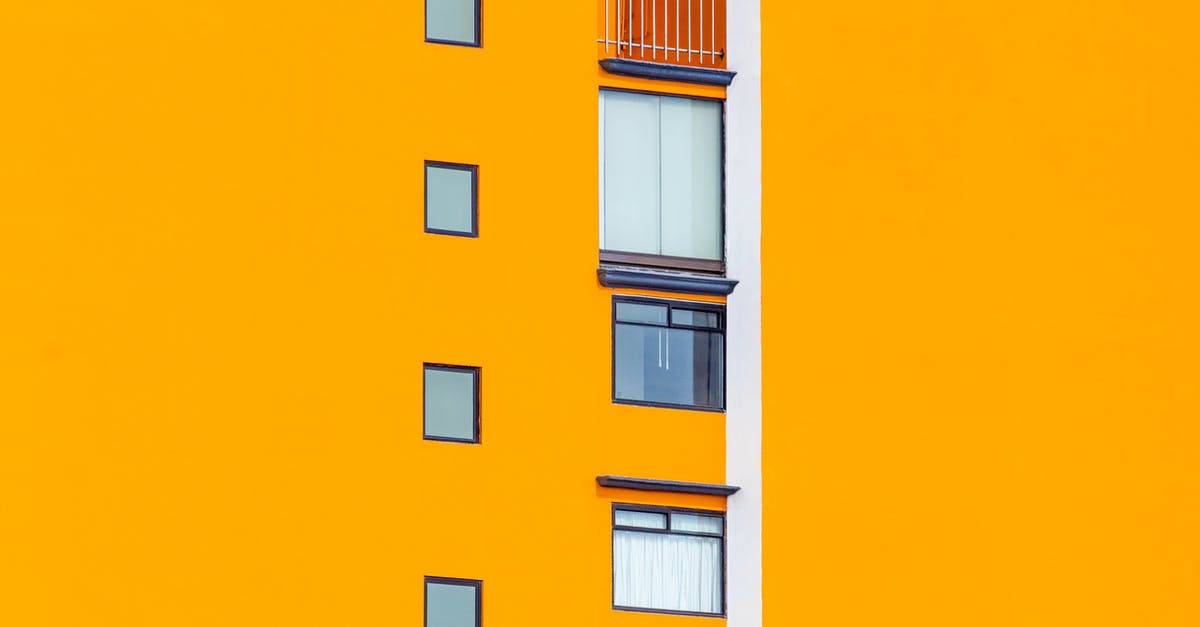 Can I rent a small plane (Cessna) in Europe? - Facade of residential house with bright orange wall with small glass glass windows in daylight in street in city outside Can I rent a small plane (Cessna) in Europe? - Facade of residential house with bright orange wall with small glass glass windows in daylight in street in city outside