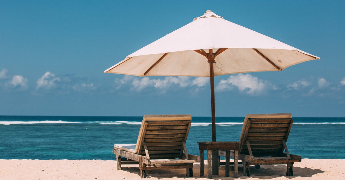 Can I reserve a beach spot by leaving an umbrella and lounge chair overnight (Italy)? - Brown Wooden Chair on Beach Can I reserve a beach spot by leaving an umbrella and lounge chair overnight (Italy)? - Brown Wooden Chair on Beach