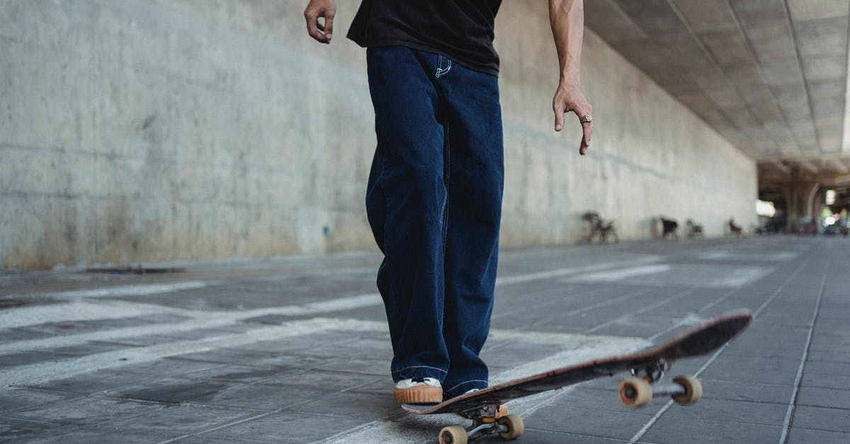 Can I roller skate on the street in France? - Crop man with skateboard on street Can I roller skate on the street in France? - Crop man with skateboard on street