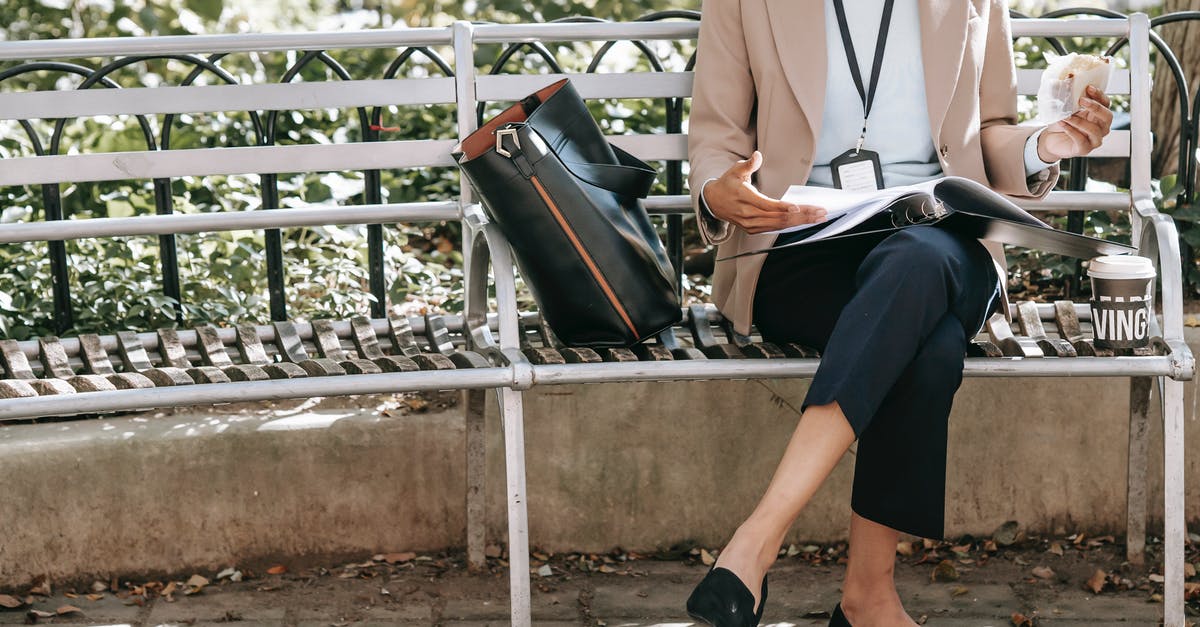 Can I safely eat whatever goes through the x-ray machine? - Crop unrecognizable female student reading papers in folder while eating sandwich on bench in park Can I safely eat whatever goes through the x-ray machine? - Crop unrecognizable female student reading papers in folder while eating sandwich on bench in park