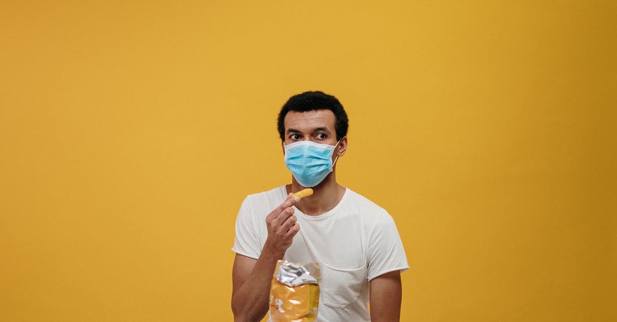 Can I safely eat whatever goes through the x-ray machine? - Man in White Crew Neck T-shirt Eating Chips Can I safely eat whatever goes through the x-ray machine? - Man in White Crew Neck T-shirt Eating Chips