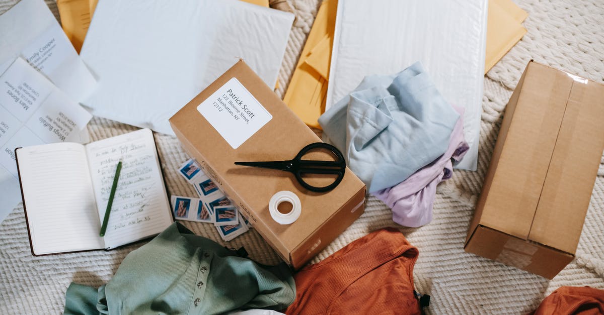 Can I send a different passport than I applied for the Canadian visa with? - From above of various carton boxes and labels near clothes on surface in room