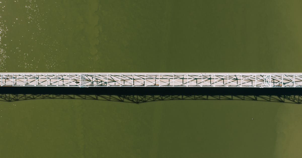 Can I stay in Schengen area after my visa still valid but breach the condition - Aerial top view of modern motor bridge crossing vast rippling river on sunny day Can I stay in Schengen area after my visa still valid but breach the condition - Aerial top view of modern motor bridge crossing vast rippling river on sunny day