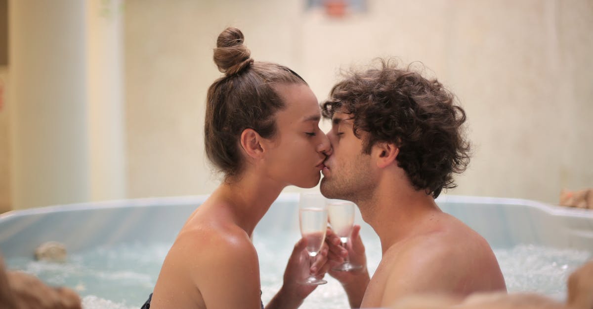 Can I take a case of wine transiting through Dubai? - Happy couple kissing in bath during romantic leisure at home Can I take a case of wine transiting through Dubai? - Happy couple kissing in bath during romantic leisure at home