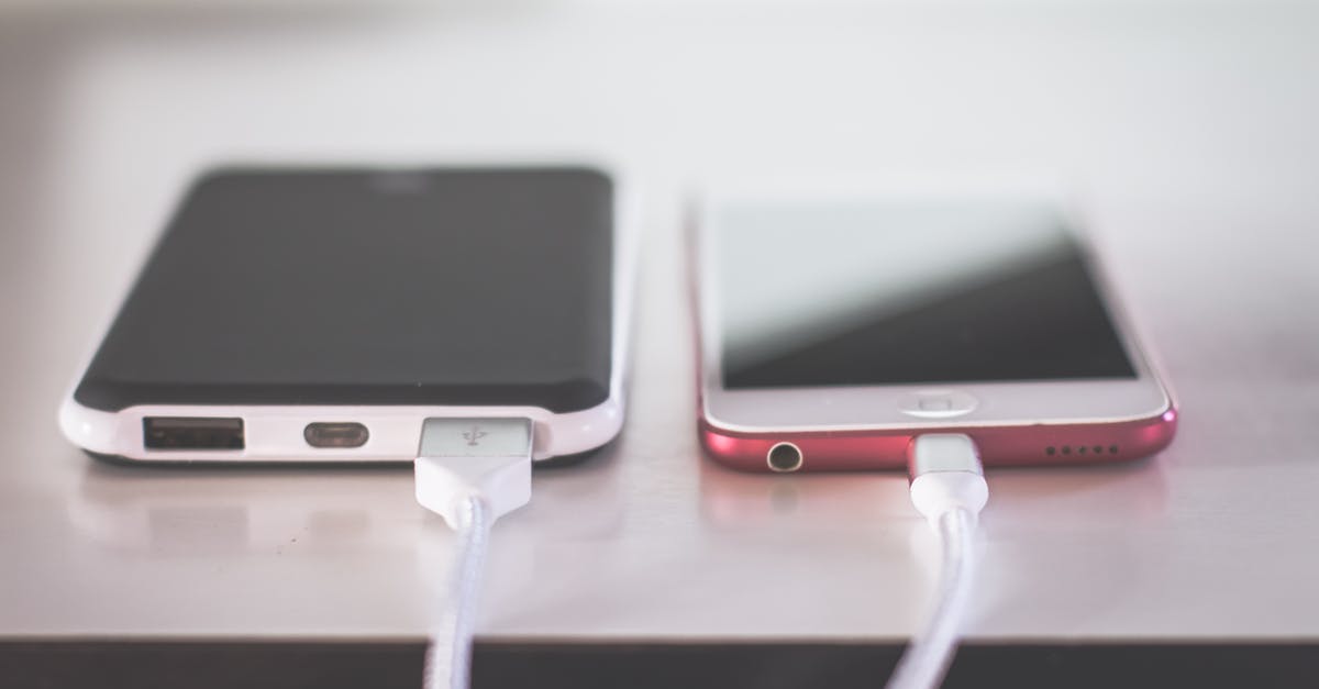 Can I take a fully-charged portable phone charger on a plane? [duplicate] - Closed Up Photography of Two Iphones