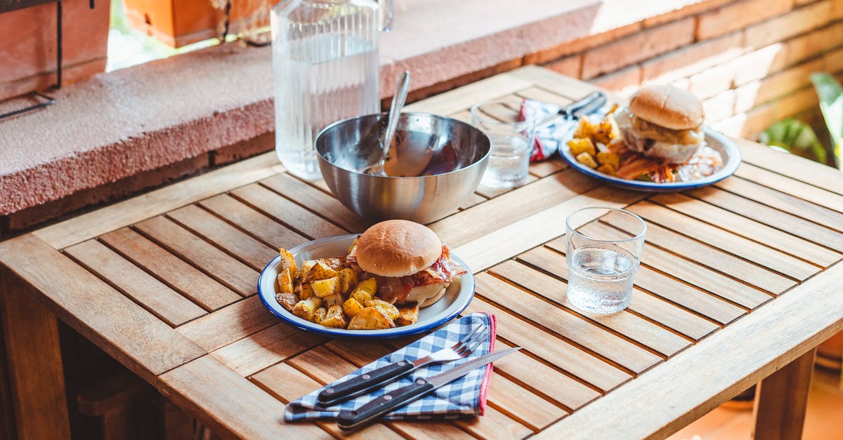 Can I take a metal knife and fork through airport security? - Appetizing burgers and potato wedges on table