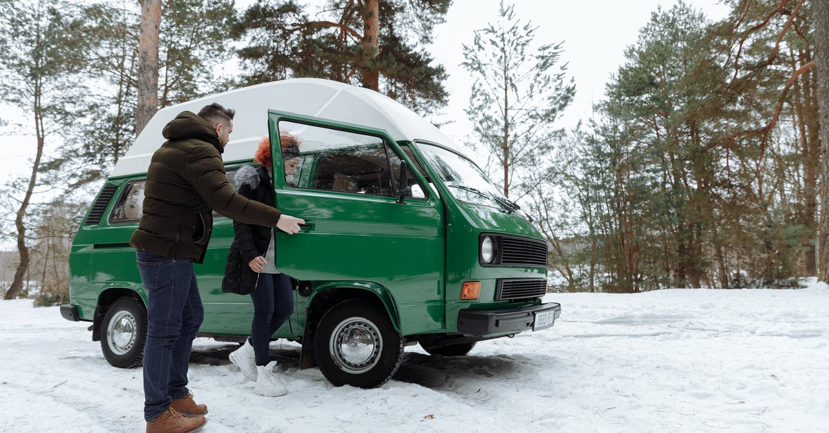 Can I take a scheduled bus on an ice road? - Man in Green Jacket Standing Beside Green Car Can I take a scheduled bus on an ice road? - Man in Green Jacket Standing Beside Green Car