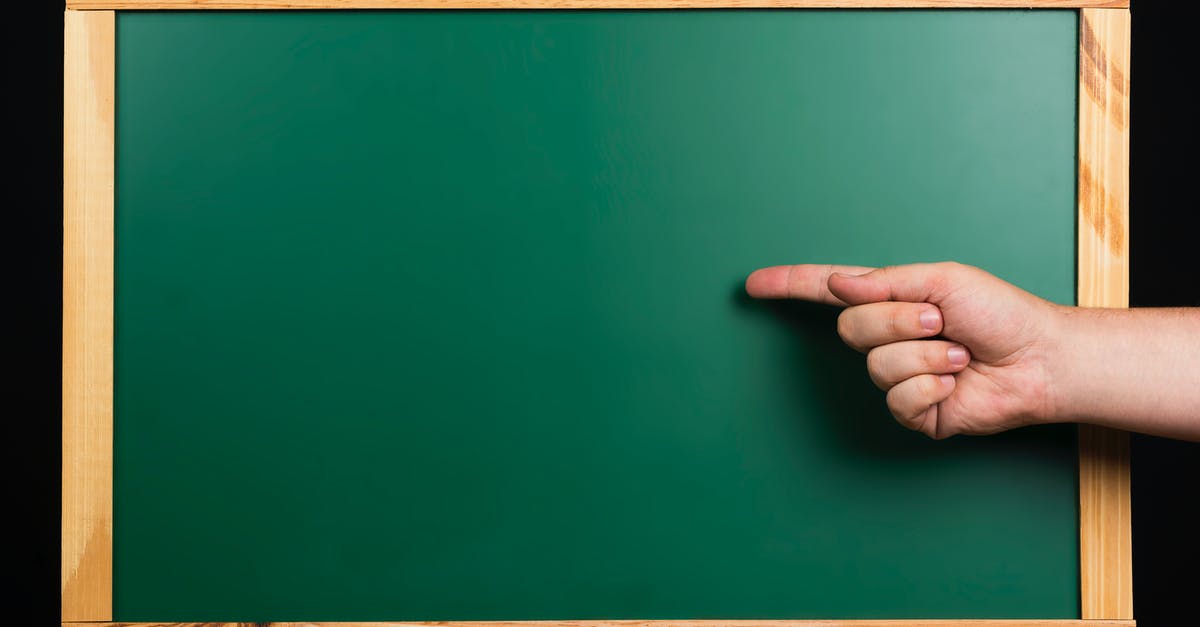 Can I take a tripod on board in my hand luggage? [closed] - Persons Hand on Green Board