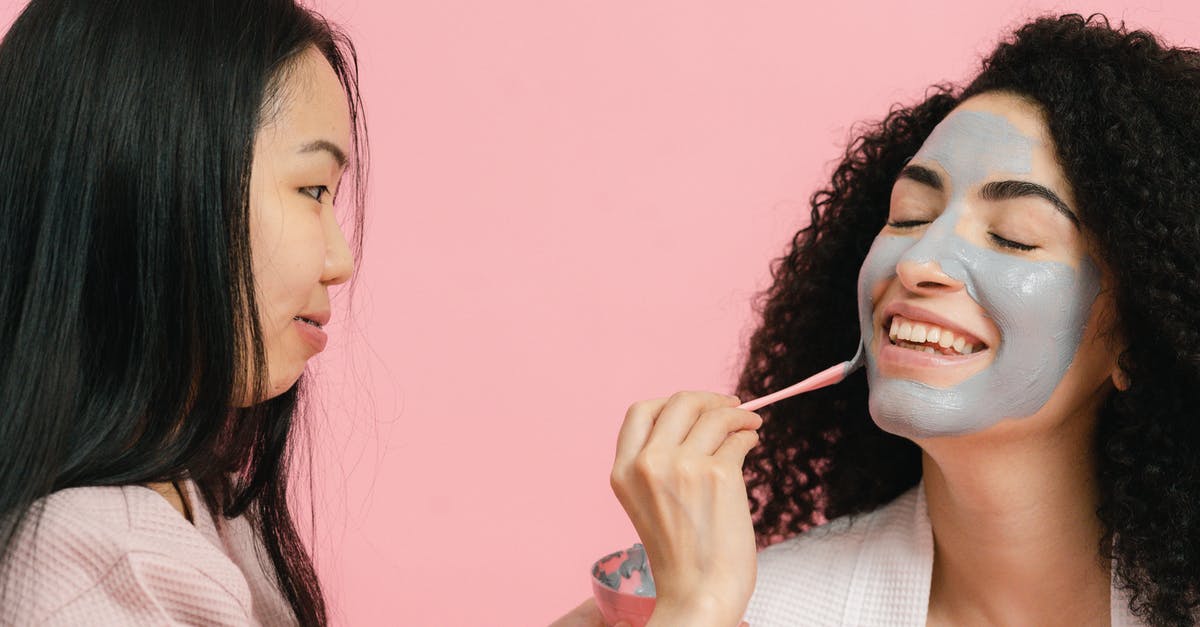 Can I take a wrapped gift of skin care products with me on the airplane? - Woman putting on cosmetic mask on face of other woman Can I take a wrapped gift of skin care products with me on the airplane? - Woman putting on cosmetic mask on face of other woman