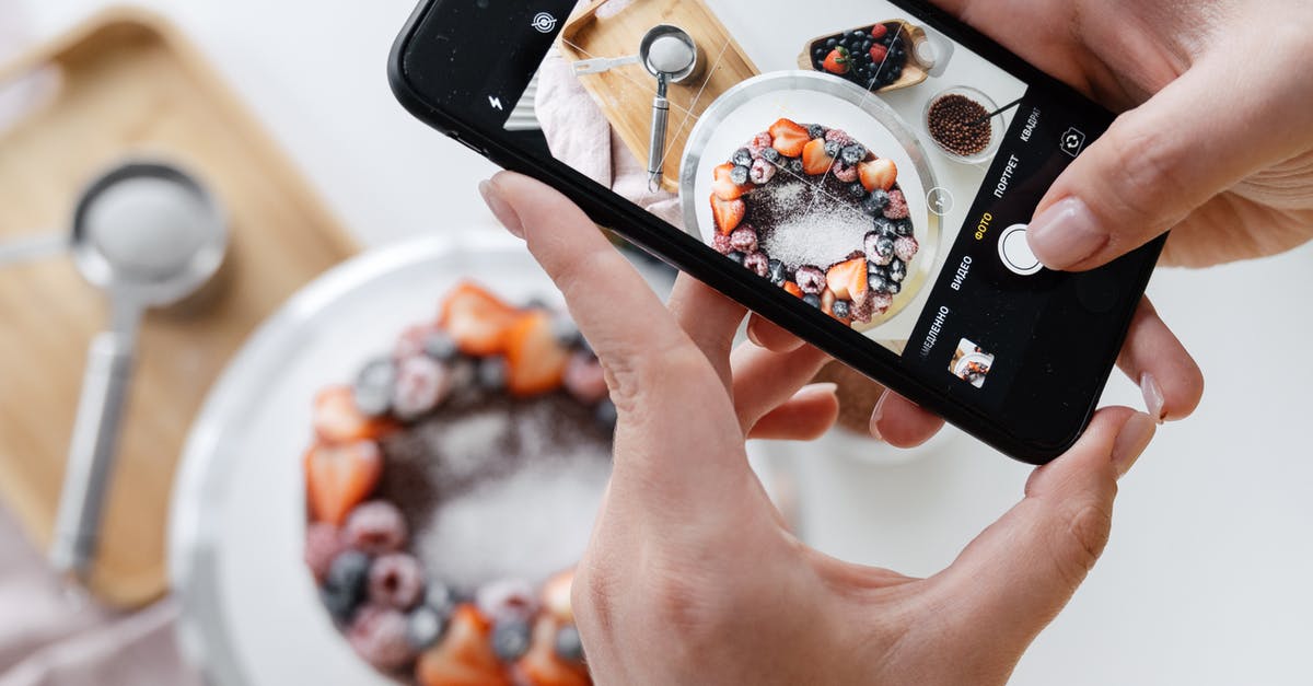Can I take chocolate to Australia? - Woman hand taking photo on smartphone of delicious decorated cake Can I take chocolate to Australia? - Woman hand taking photo on smartphone of delicious decorated cake