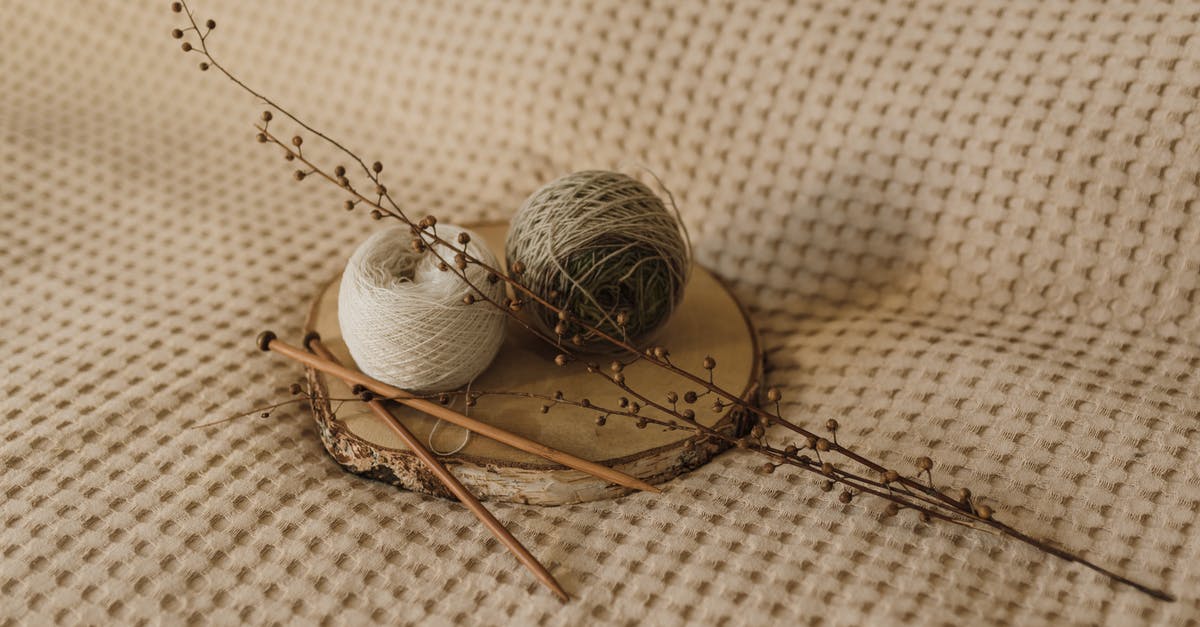 Can I take knitting needles on an international flight? - Rolls of Yarn and a Pair of Knitting Needles on a Wooden Board Can I take knitting needles on an international flight? - Rolls of Yarn and a Pair of Knitting Needles on a Wooden Board