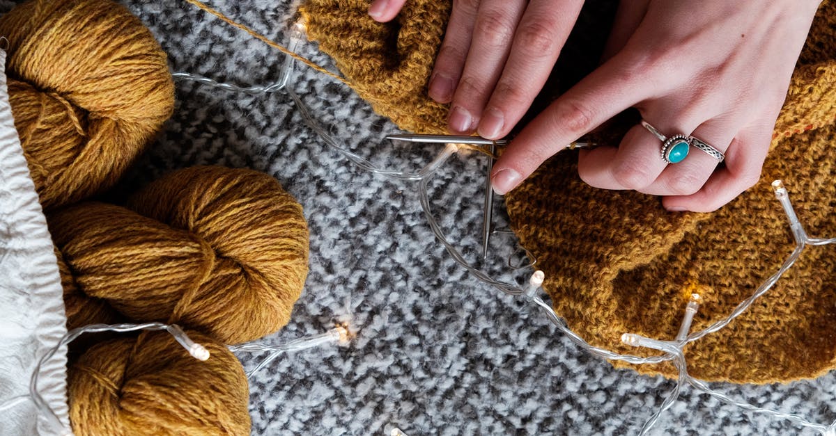 Can I take knitting needles on an international flight? - Photo Of Person Holding Brown Yarn Roll Can I take knitting needles on an international flight? - Photo Of Person Holding Brown Yarn Roll