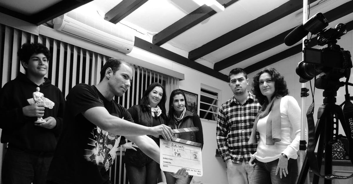 Can I take legal action against a booking agency refusing to refund airport taxes? [closed] - Grayscale Photo of Group of People in Recording Session