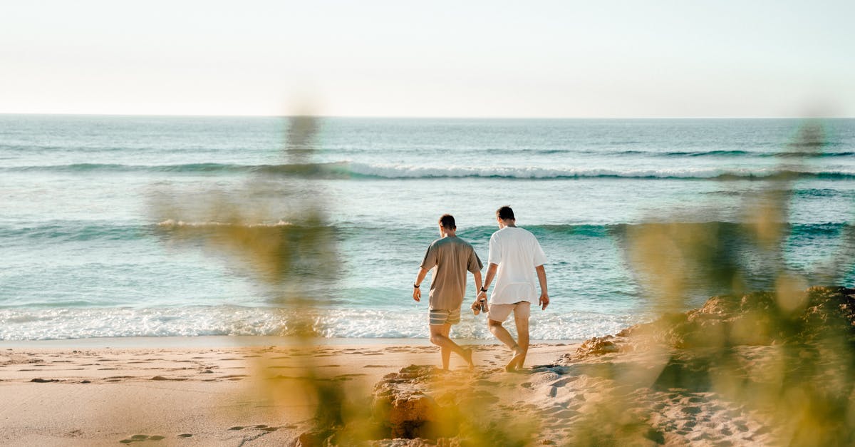 Can I transfer airside between two international tickets at LAX? - Man and Woman Walking on Seashore Can I transfer airside between two international tickets at LAX? - Man and Woman Walking on Seashore