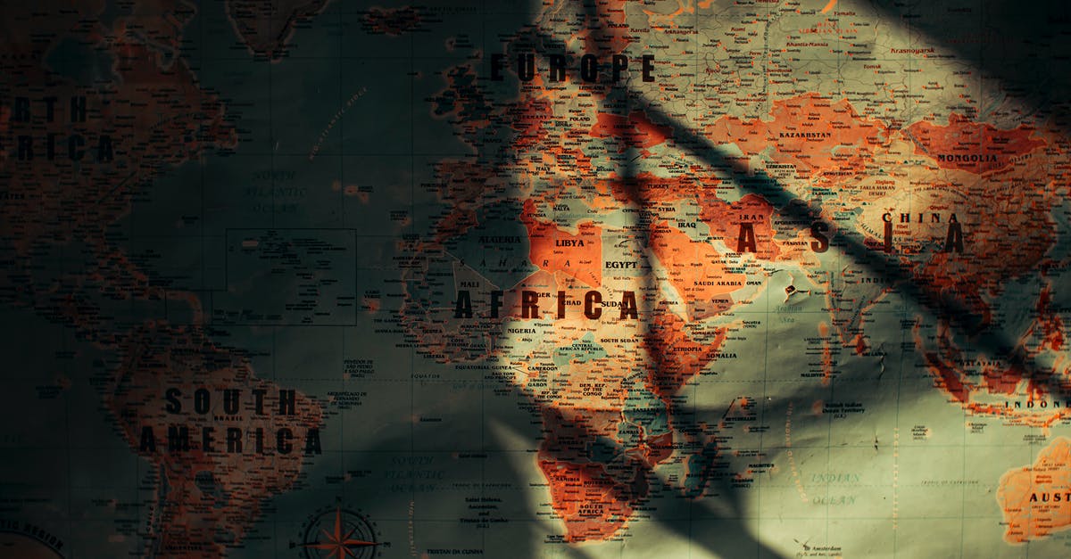 Can I transit in the US travelling from South Africa - From above of sunlit aged paper world map with continents countries and oceans Can I transit in the US travelling from South Africa - From above of sunlit aged paper world map with continents countries and oceans