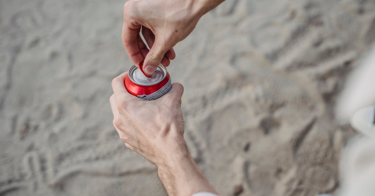 Can I transit via Schengen with visa-free days expired? - From above of crop anonymous male opening can of drink standing on sandy beach Can I transit via Schengen with visa-free days expired? - From above of crop anonymous male opening can of drink standing on sandy beach