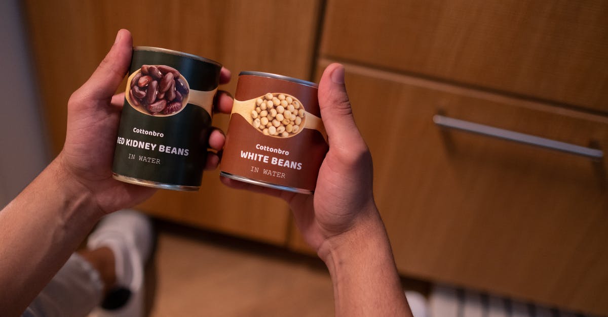 Can I transport canned food in hand luggage in Europe? - Hands of a Person Holding Tin Canned Food Can I transport canned food in hand luggage in Europe? - Hands of a Person Holding Tin Canned Food