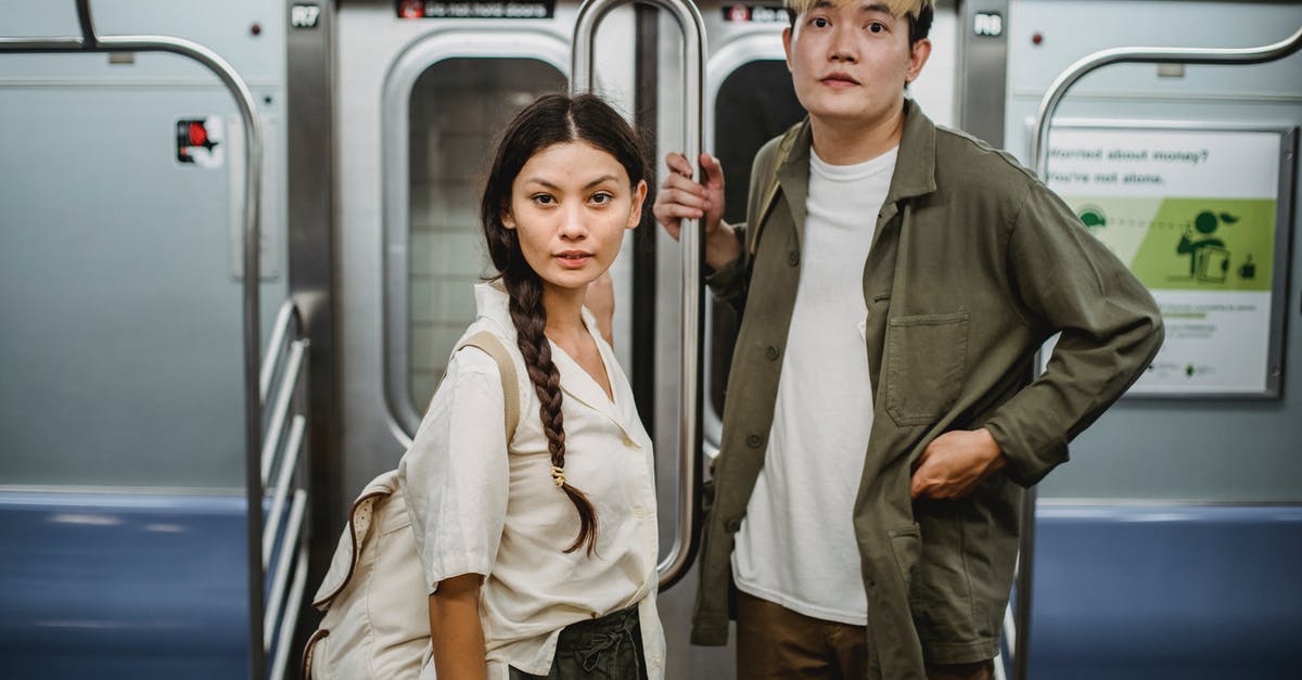 Can I travel Italian regional train tickets in the opposite direction of travel? - Trendy young Asian couple holding handrail while commuting by subway train Can I travel Italian regional train tickets in the opposite direction of travel? - Trendy young Asian couple holding handrail while commuting by subway train