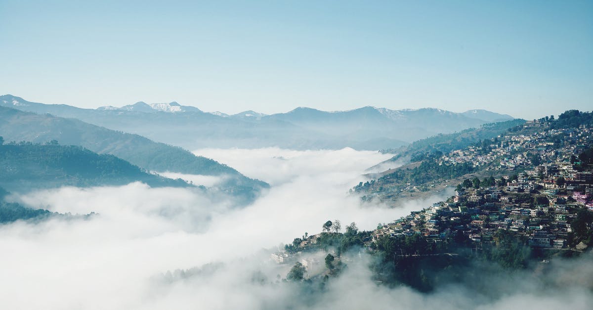 Can I travel to another country from the US without a passport if I have my green card - Peaceful landscape of remote town on slope of green mountain in highland valley covered with fog Can I travel to another country from the US without a passport if I have my green card - Peaceful landscape of remote town on slope of green mountain in highland valley covered with fog