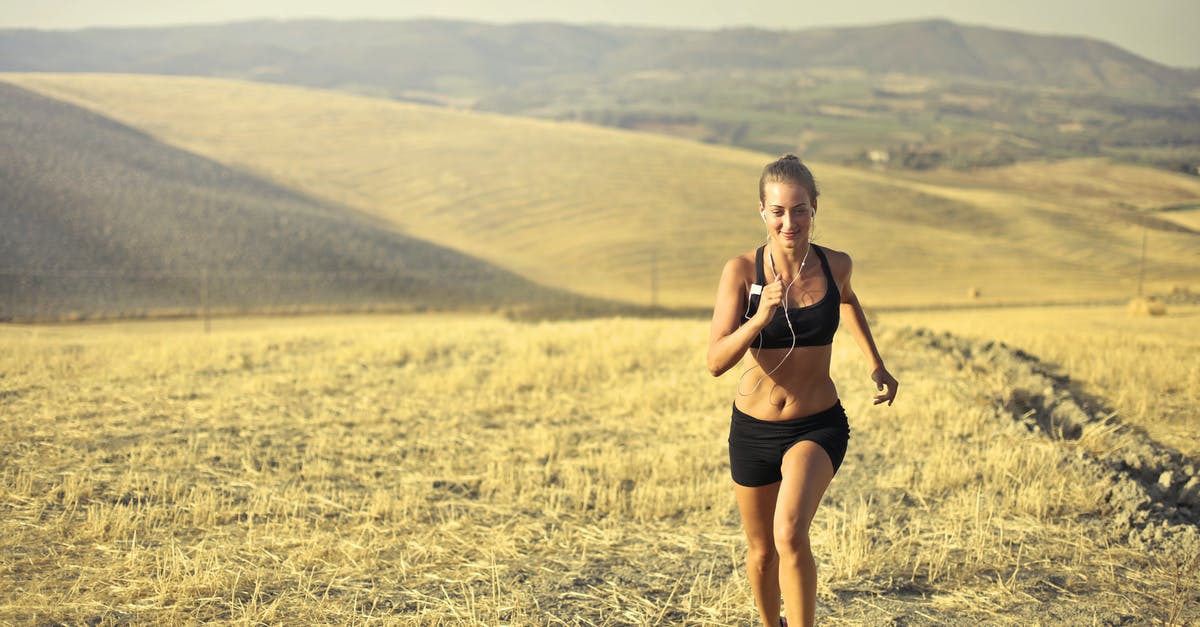 Can I travel to Cyprus using Schengen Visa? [duplicate] - Powerful young female athlete in activewear running along hill on background of mountainous landscape and listening to music in earphones during cardio training