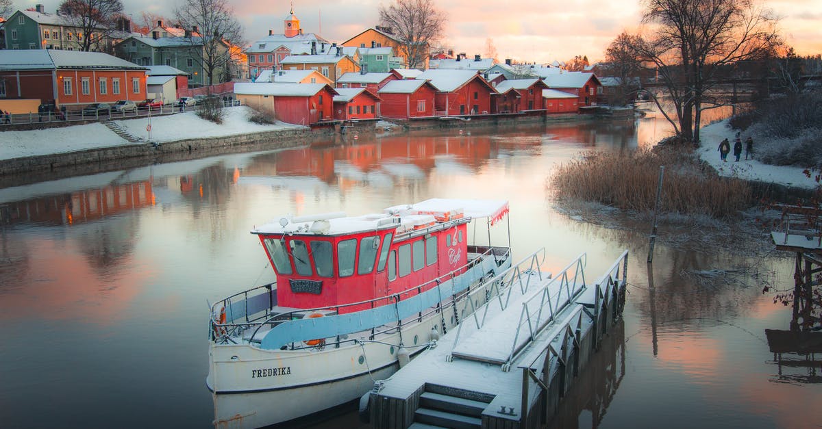 Can I travel to Finland with a multiple entry visa issued for Italy? - White Boat on Water Near Houses