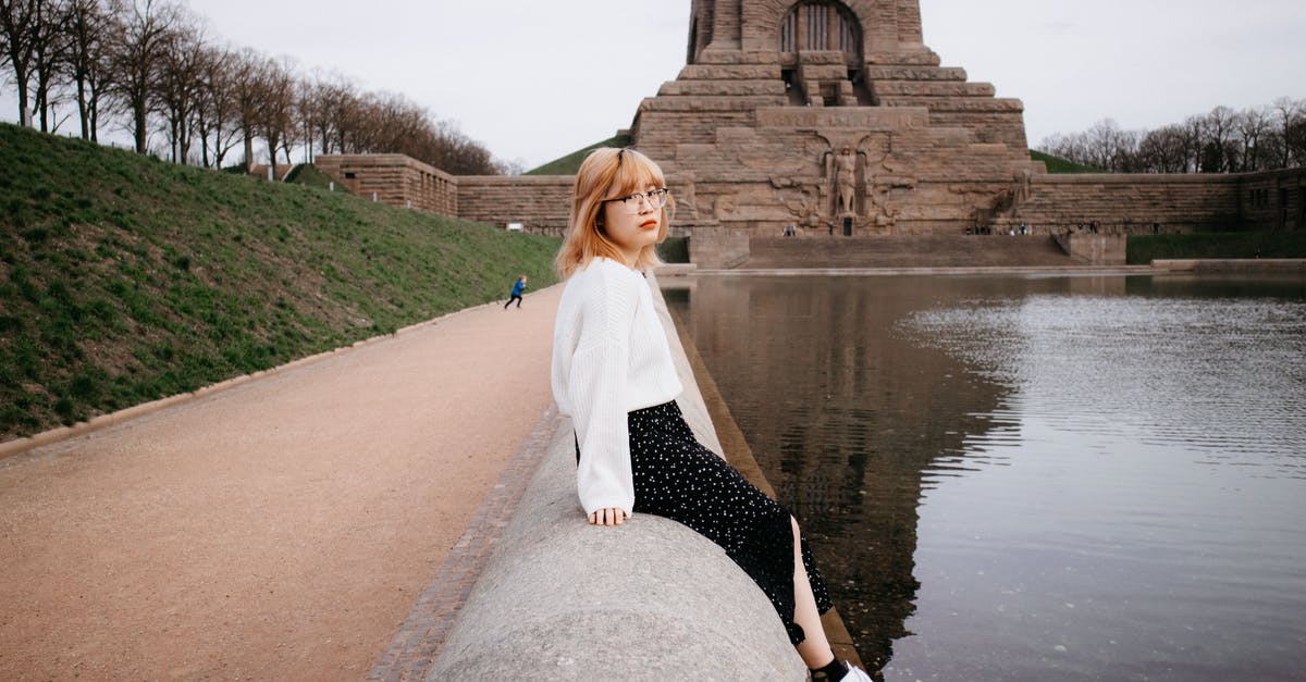 Can I travel to Germany with a criminal record? - A Woman in White Knitted Sweater Sitting Beside the Lake Can I travel to Germany with a criminal record? - A Woman in White Knitted Sweater Sitting Beside the Lake