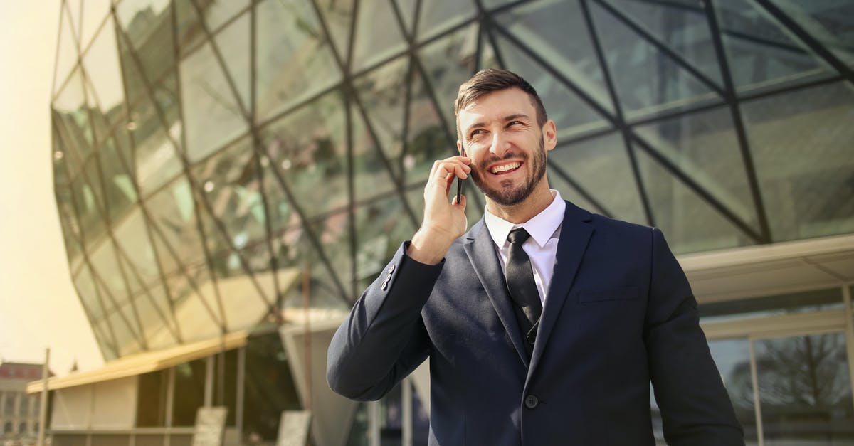 Can I travel to Ireland using a refugee document, or do I need a visa? - Man in Black Suit Jacket While Using Smartphone Can I travel to Ireland using a refugee document, or do I need a visa? - Man in Black Suit Jacket While Using Smartphone