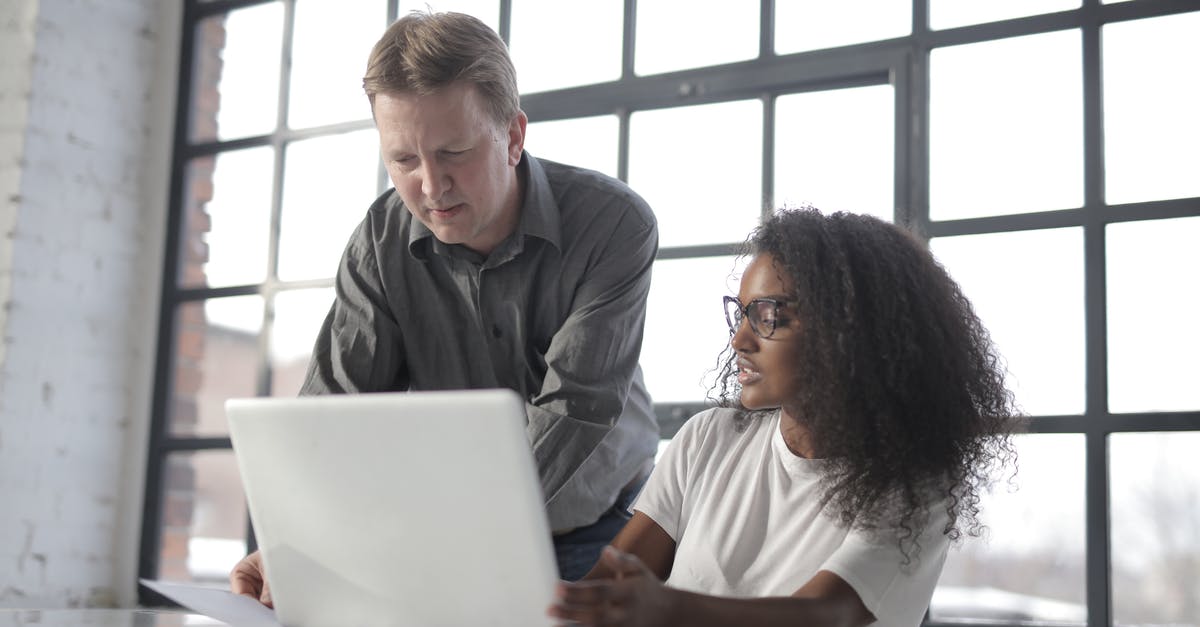 Can I use a different travel document than APIS? - Concentrated diverse coworkers of different age with laptop and documents during office work