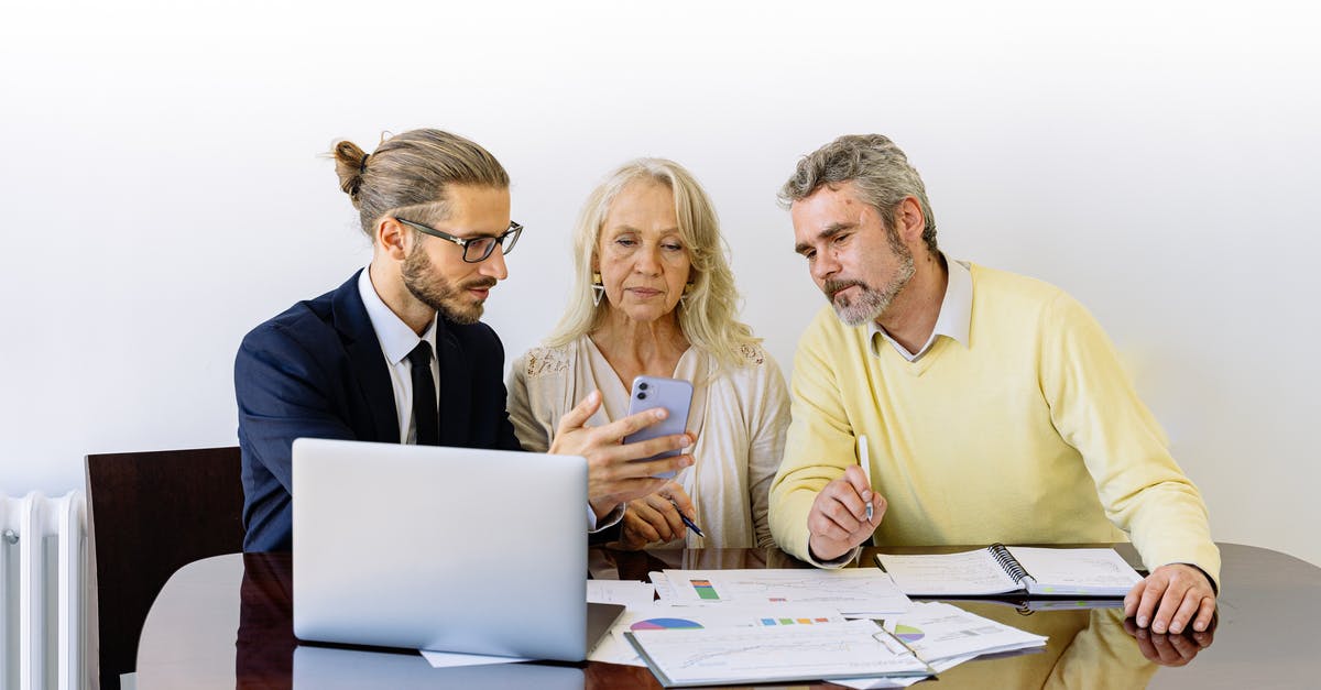 Can I use a mortgage loan paid by my employer as source of funds for my Uk visitor visa application [closed] - Man and Woman Sitting at the Table