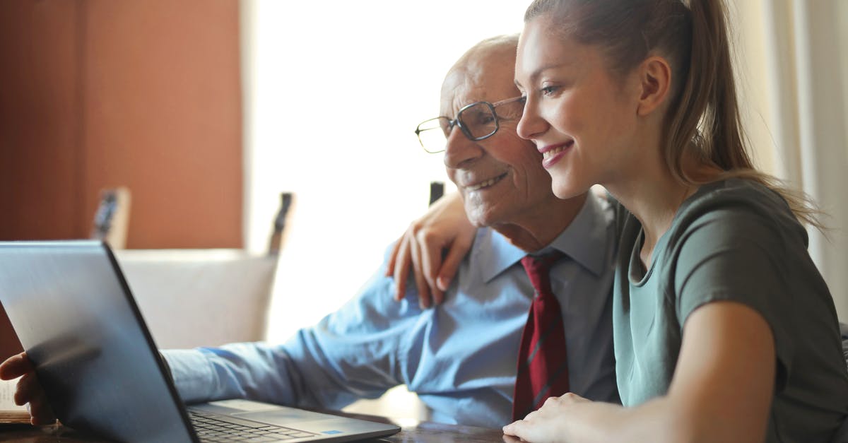 Can I use a priority seat if it is vacant? - Young positive woman helping senior man using laptop Can I use a priority seat if it is vacant? - Young positive woman helping senior man using laptop