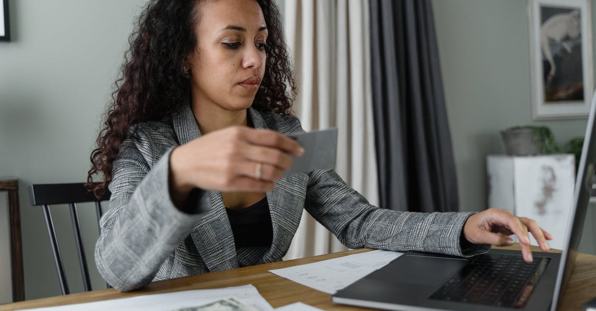 Can I use Australian dollars at the Kuala Lumpur airport? - A Woman Using a Laptop Near Cash Money Can I use Australian dollars at the Kuala Lumpur airport? - A Woman Using a Laptop Near Cash Money