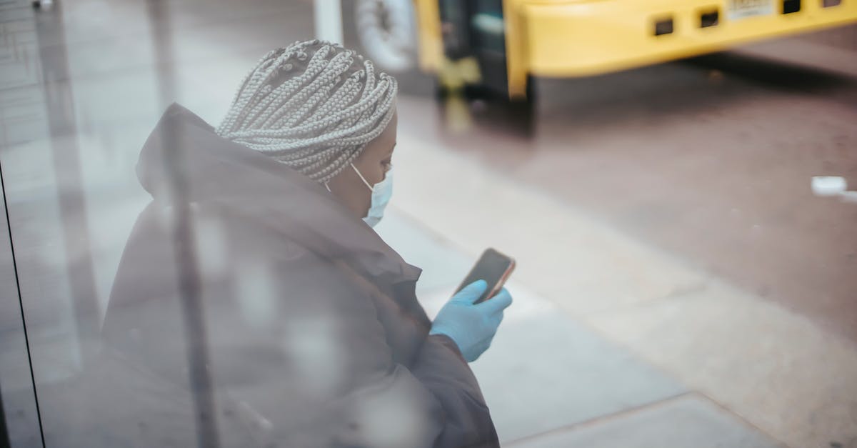 Can I use my birth certificate as identification on a bus in Texas? - Through glass wall side view of African American female doctor using cellphone on pavement against bus on urban road Can I use my birth certificate as identification on a bus in Texas? - Through glass wall side view of African American female doctor using cellphone on pavement against bus on urban road
