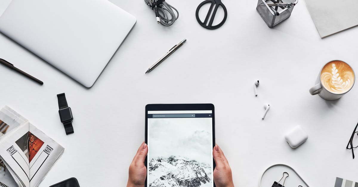 Can I use my ipad charger bought in Japan in Los Angeles? - Person Holding Black Ipad