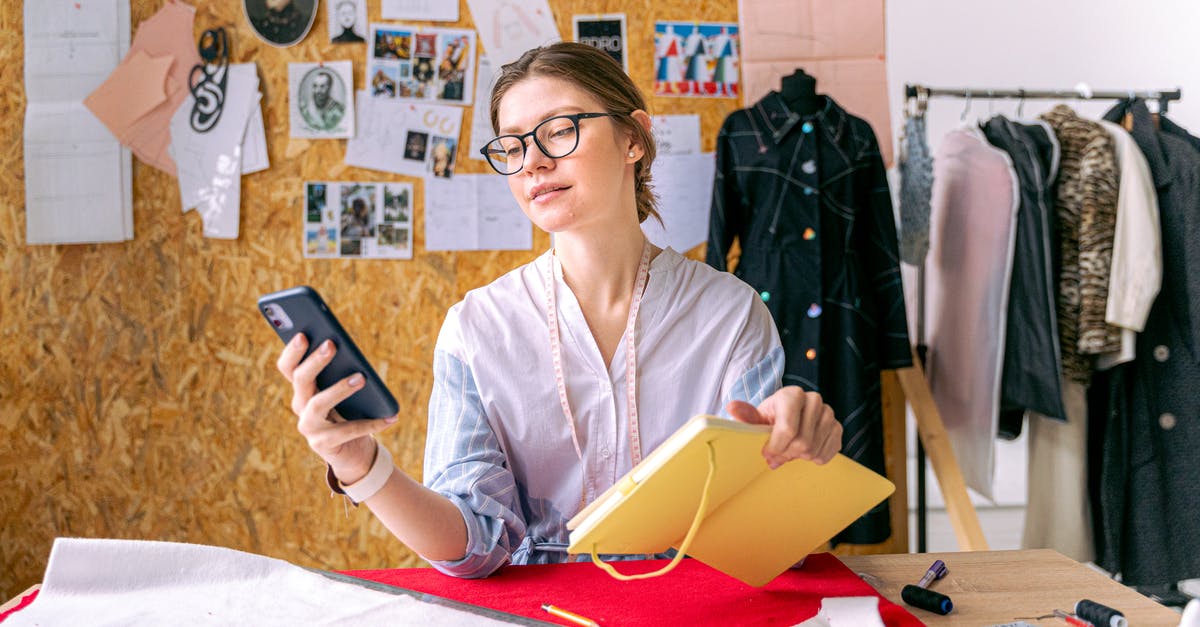 Can I use my notebook while in the airplane? - Fashion Designer Sitting and Using Her Smartphone 