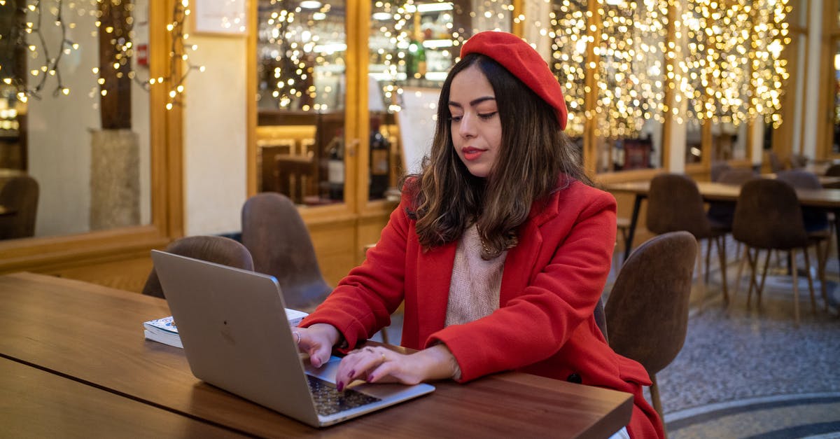 Can I use only buses in Paris instead of the Métro? - Woman in Red Coat Using Laptop on Wooden Table Can I use only buses in Paris instead of the Métro? - Woman in Red Coat Using Laptop on Wooden Table