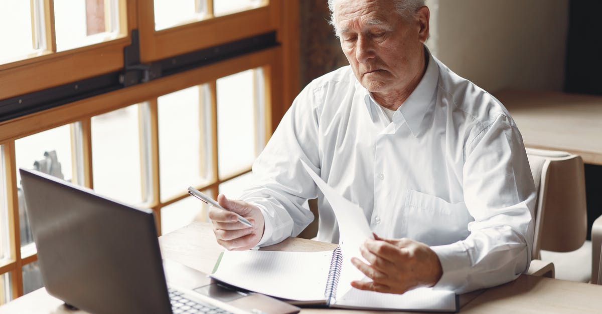 Can i use PayPal account statment for a UK Visitor Visa? - Serious gray haired aged man in white shirt sitting at table and browsing laptop while checking notes in modern office Can i use PayPal account statment for a UK Visitor Visa? - Serious gray haired aged man in white shirt sitting at table and browsing laptop while checking notes in modern office