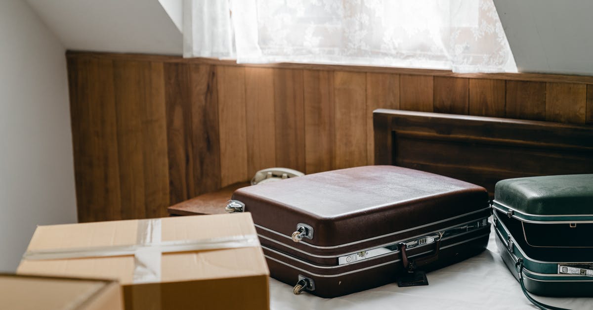 Can I use plastic bag as a personal item - From above of brown and green vintage suitcases and packed carton boxes placed on bed with sheet in light room with sloping roof Can I use plastic bag as a personal item - From above of brown and green vintage suitcases and packed carton boxes placed on bed with sheet in light room with sloping roof