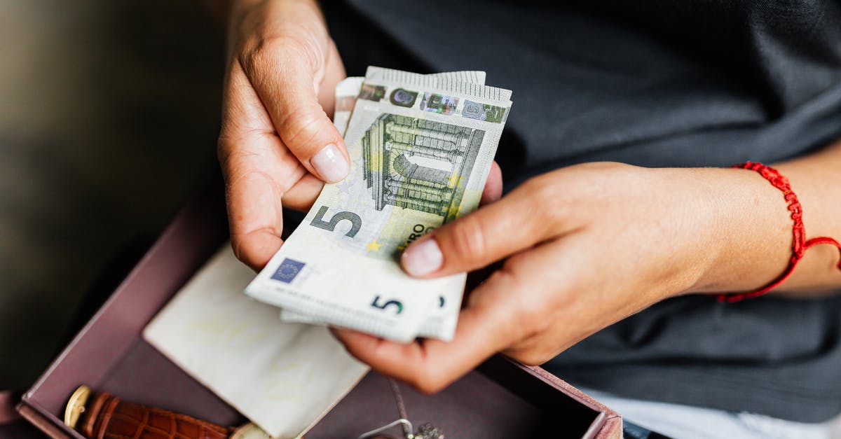 Can I use the 500 Euro notes in Greece? - Hands of a Person Holding Cash Bills