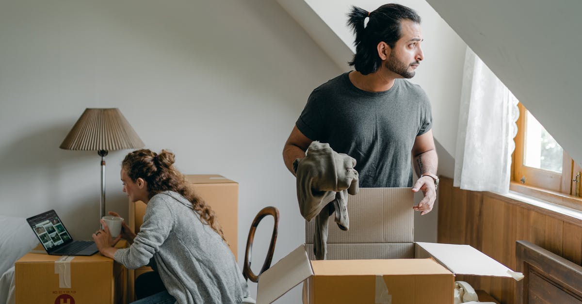 Can I use the same photo for a new Schengen visa application that was used in the previous visa? - Dreamy ethnic man getting turtleneck out of box near girlfriend