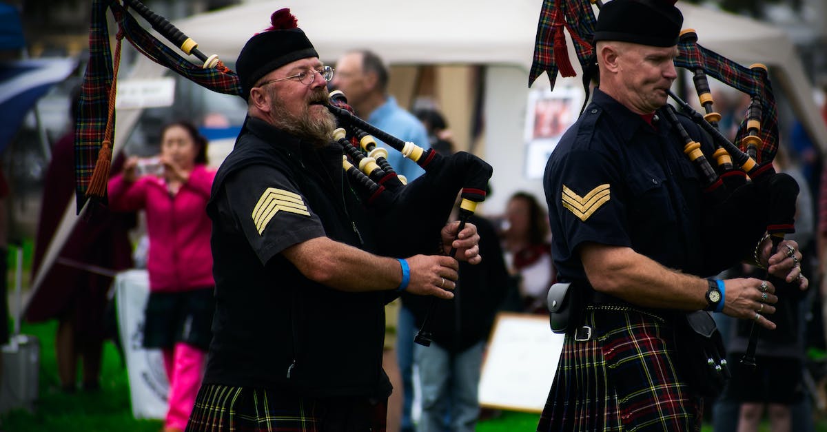 Can I wear a kilt around Europe? - Two Men Playing Wind Instruments on Ground Can I wear a kilt around Europe? - Two Men Playing Wind Instruments on Ground