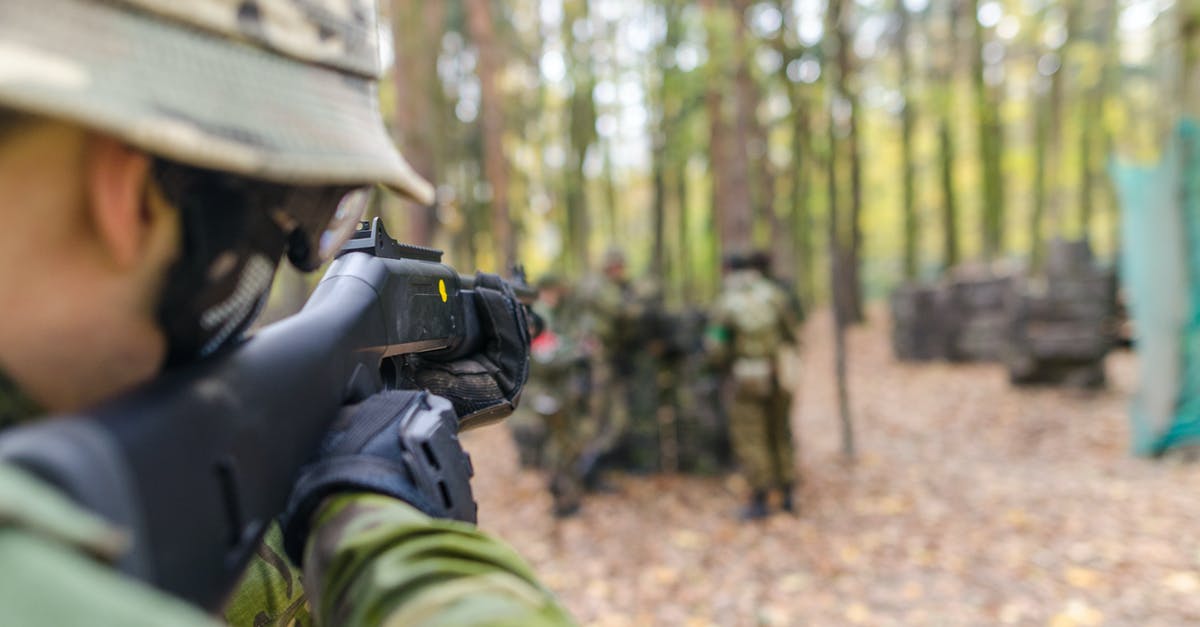 Can I wear all types of military surplus clothing in Germany? - Soldier Holding Black Assault Rifle